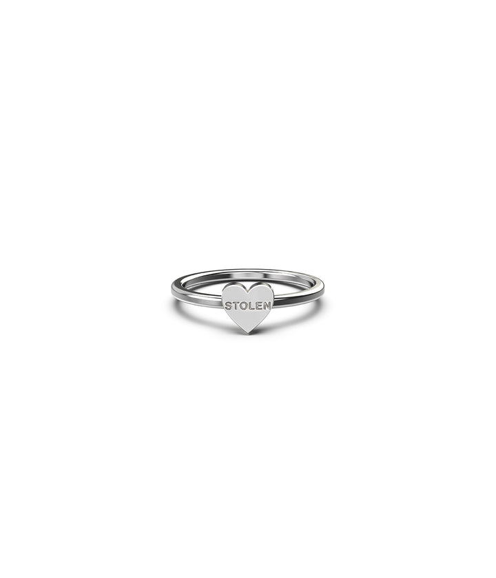 Front view of Baby Stolen Heart Ring in sterling silver on white background, showing heart face engraved with STOLEN logo.