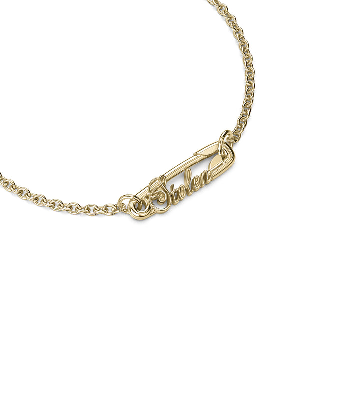 Angled view of gold bracelet highlighting  central charm.