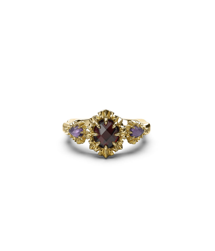 Front view of gold triple gemstone ring on white background