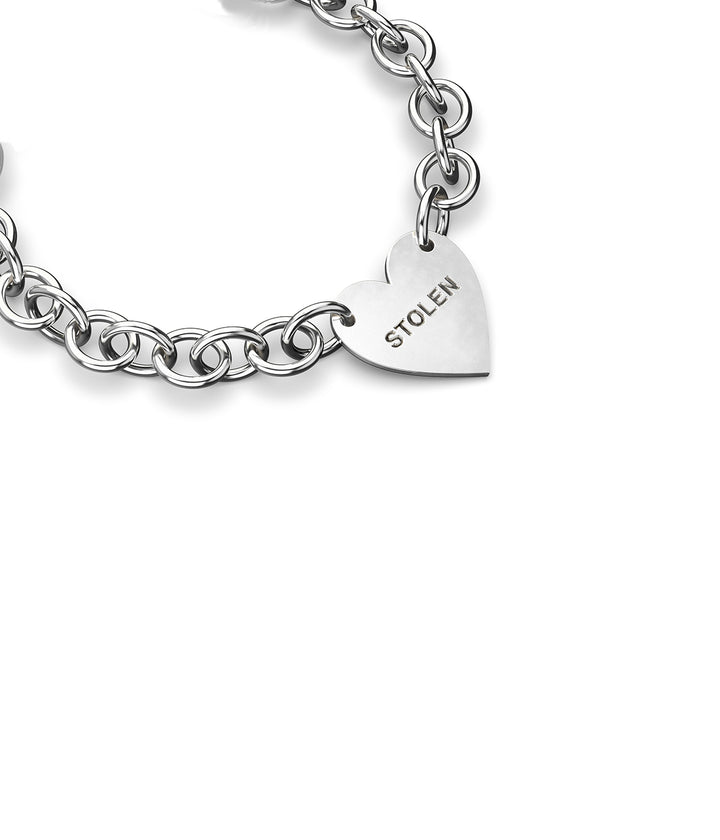 Side view of sterling silver Cold Heart Bracelet showing high-polish finish and charm.