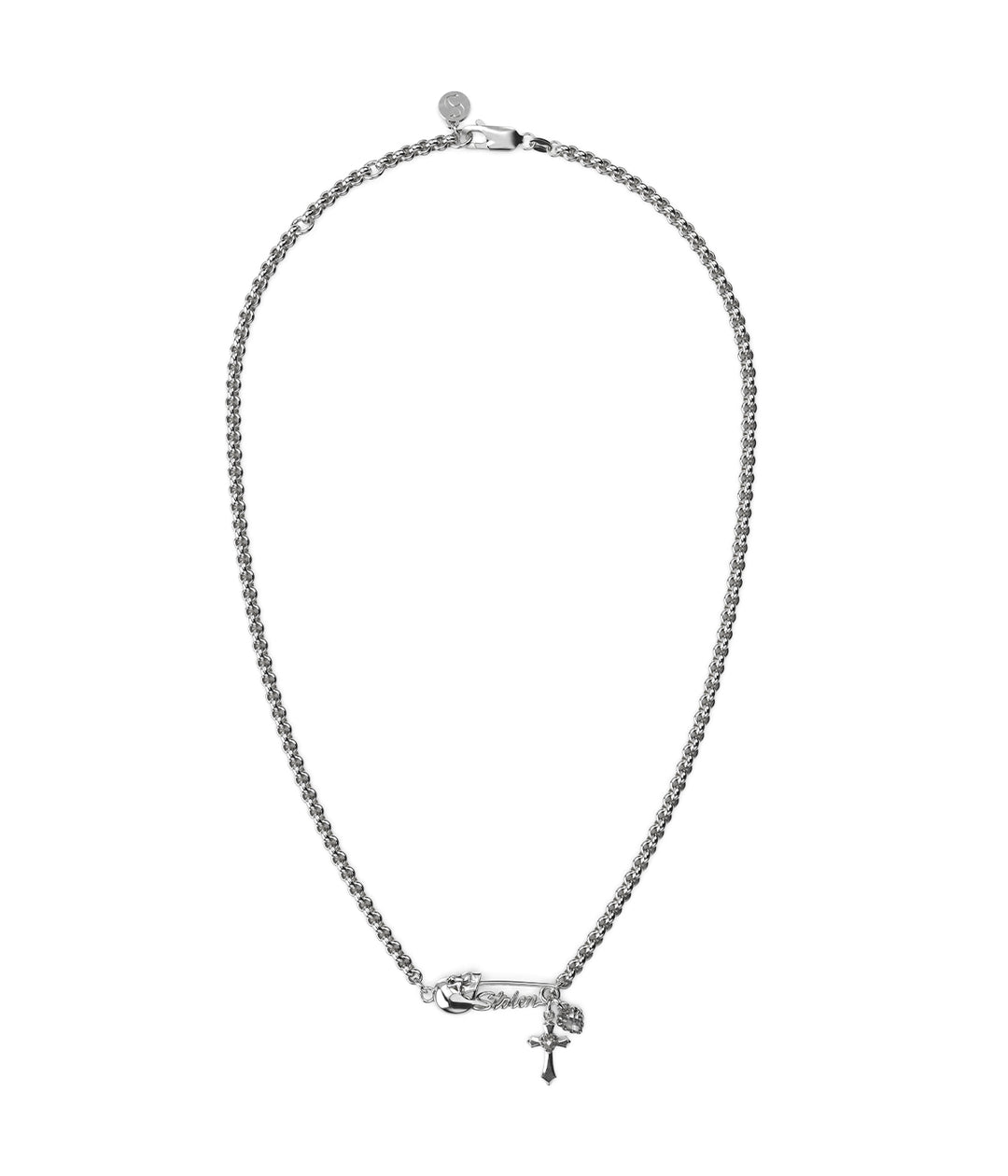 Sterling silver necklace with sculptural skull-topped safety pin and hanging charms: claw-set heart, cross, and quartz.