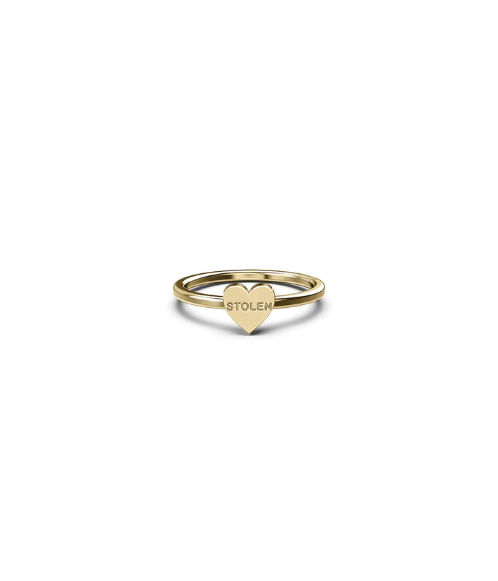 Front view of Baby Stolen Heart Ring in 18k gold-plated silver on white background, showing heart face engraved with STOLEN logo.