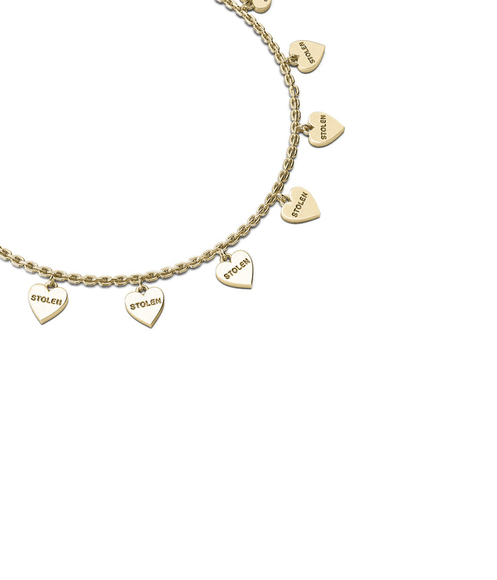 Close-up of engraved heart charms in polished gold finish