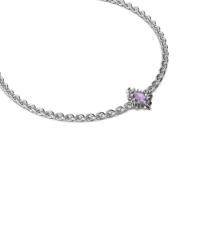 Side view of sterling silver bracelet with claw-set amethyst teardrop stone.