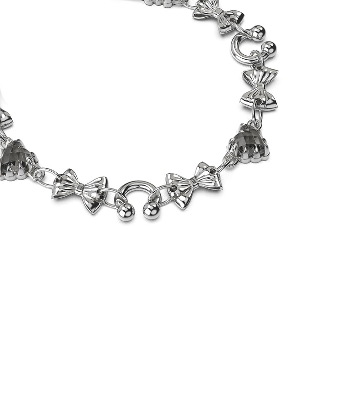 Angled view of sterling silver gothic charm bracelet showing detail of heart stones and curved links.