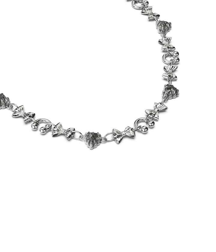 3/4 angled view of silver charm necklace showing detail and articulation