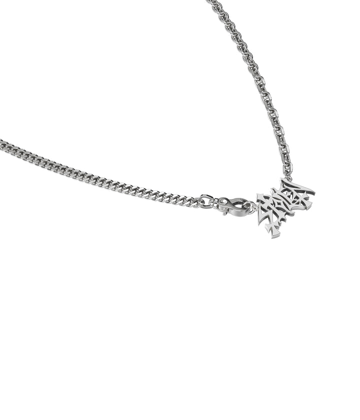 Close-up of sculptural STOLEN pendant and polished links.