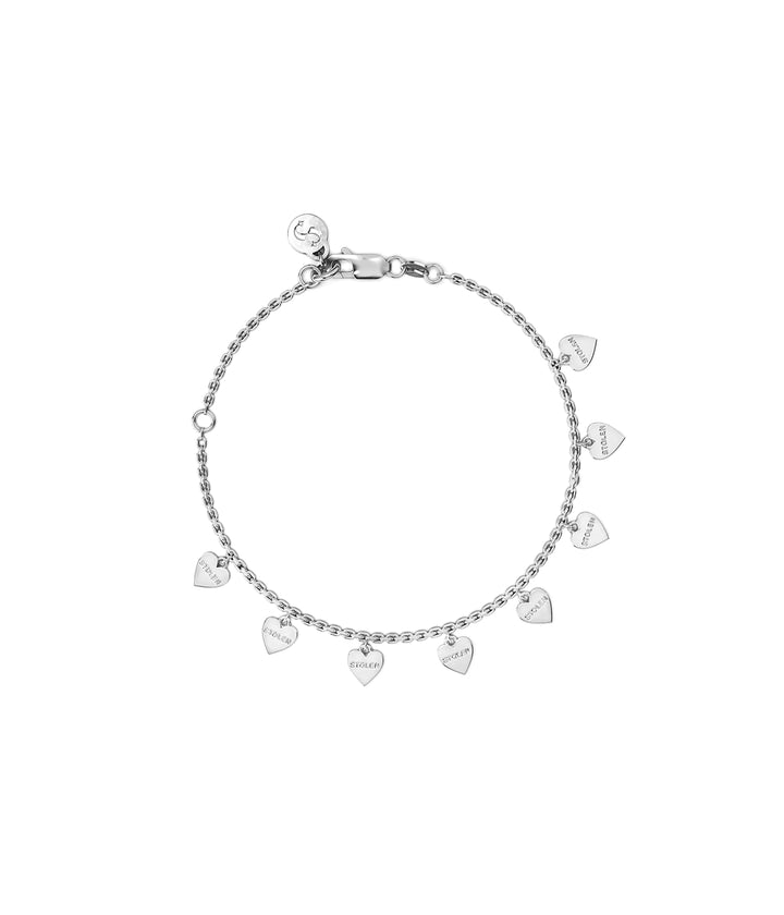 Sterling silver Stolen Heart Bracelet on white background showing engraved mini heart charms.
