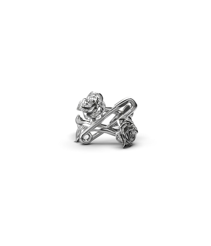 Front view of sterling silver rose and pin ring with white topaz on white background