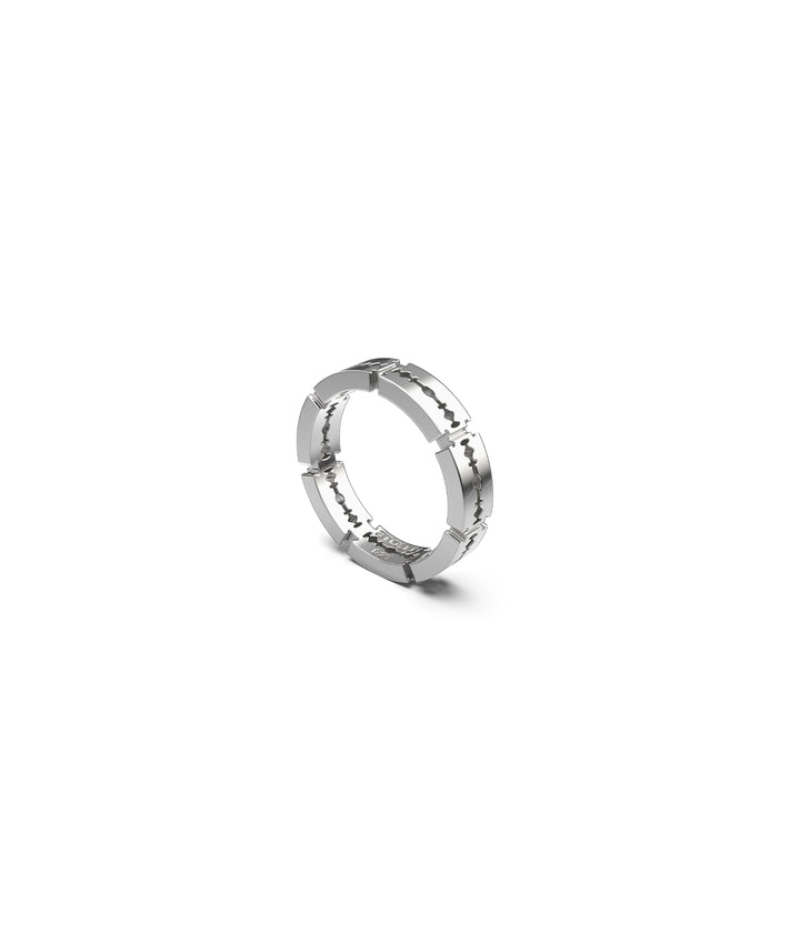 Narrow sterling silver ring with repeating razor blade design, shown in three-quarter view on white background with  detailing visible
