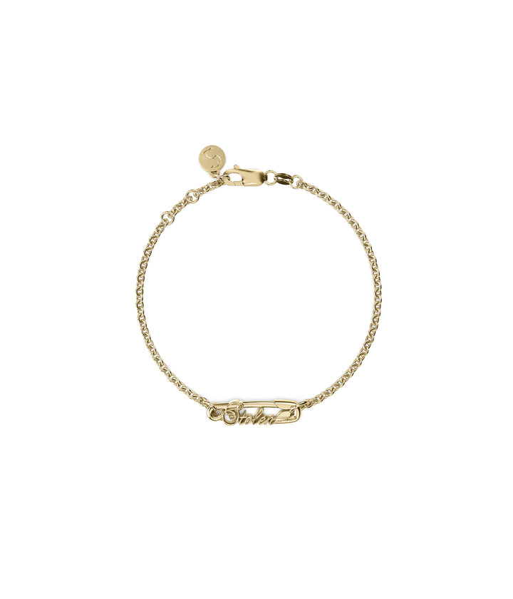 Gold-plated bracelet with engraved safety pin charm shown flat on white background.