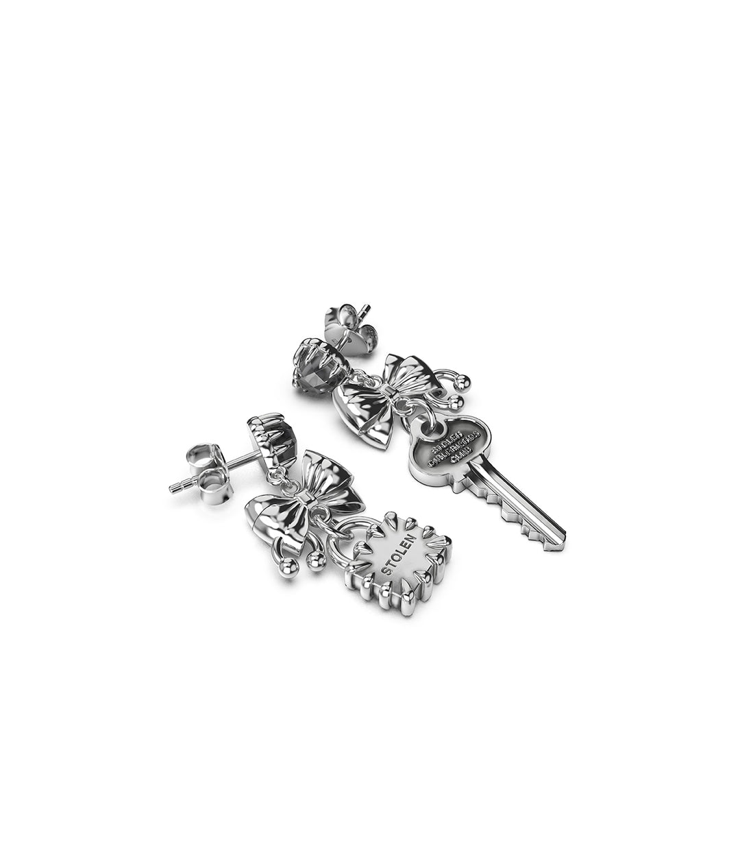 Close-up of key and lock charms engraved with brand details. Sterling silver statement earrings for formal wear