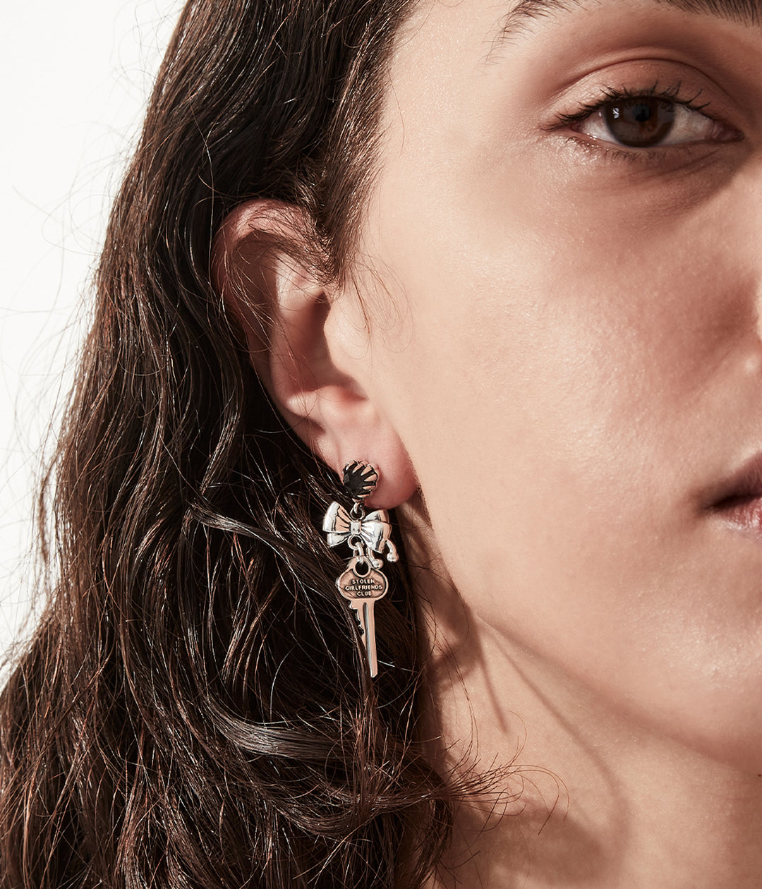 Faceted black heart stones and sculpted bows in high polish silver.