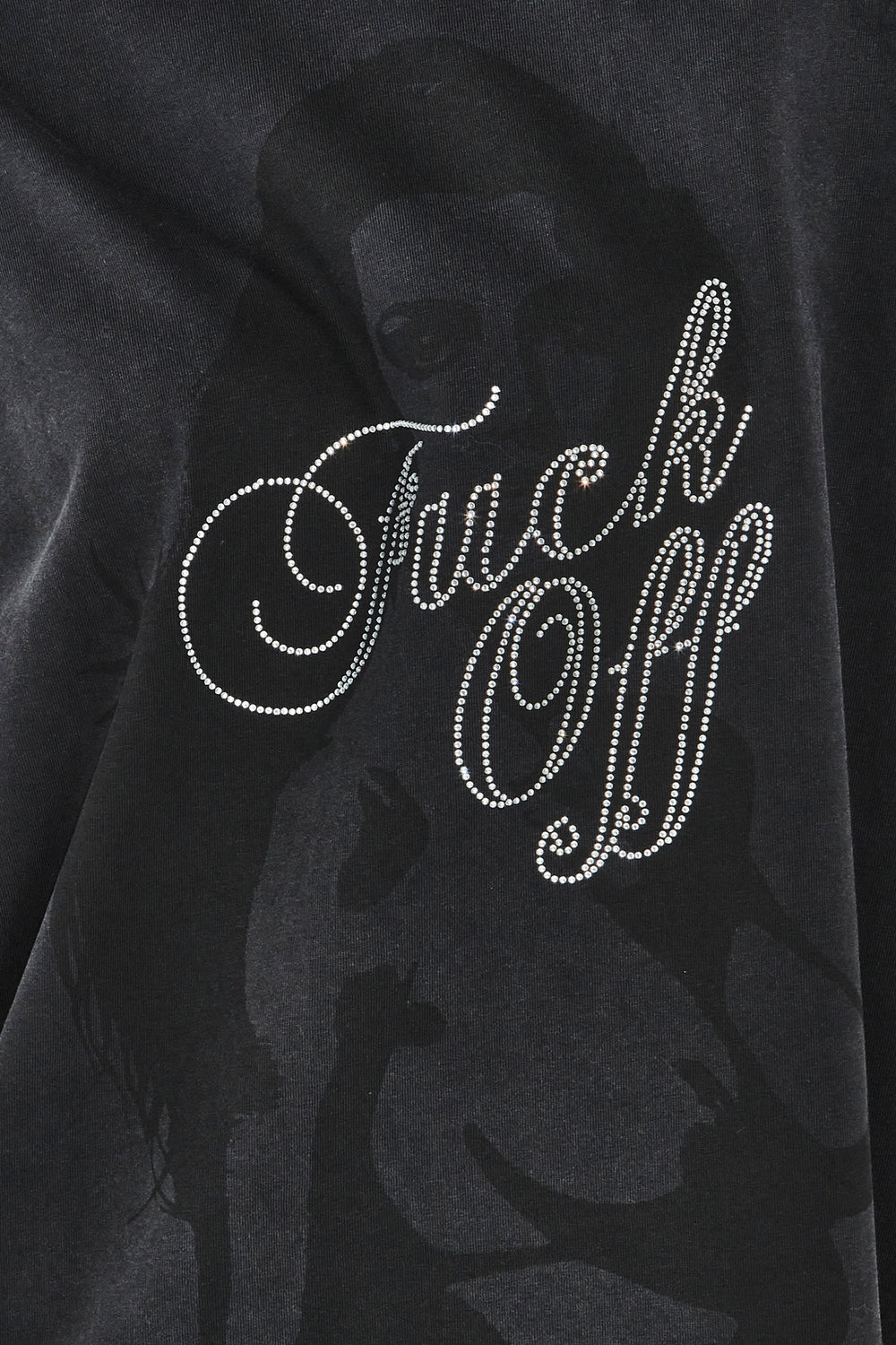 Black sweatshirt with 'F**k Off' text in rhinestones on a dark background