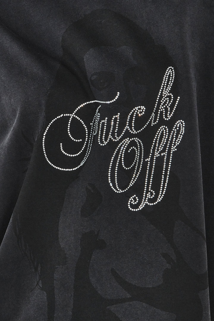 Black sweatshirt with 'F**k Off' text in rhinestones on a dark background
