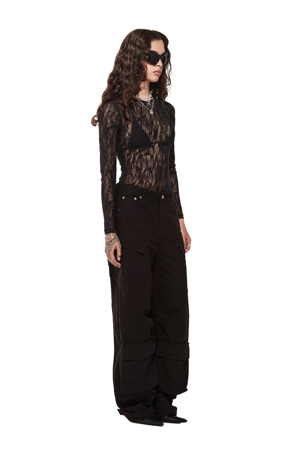 Combat Cargo Pant - Model wearing a black lace bodysuit and high-waisted black pants. Women's Black Fashion Cargo Pant 11oz Cotton-  by Stolen Girlfriends Club