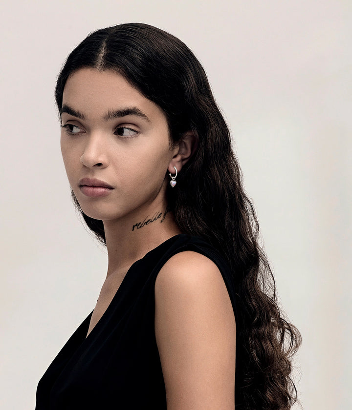 Pink Bello Opal Love Claw Anchor Earring worn on the ear, showing the suspended heart-shaped stone and polished silver hoops from a distance.