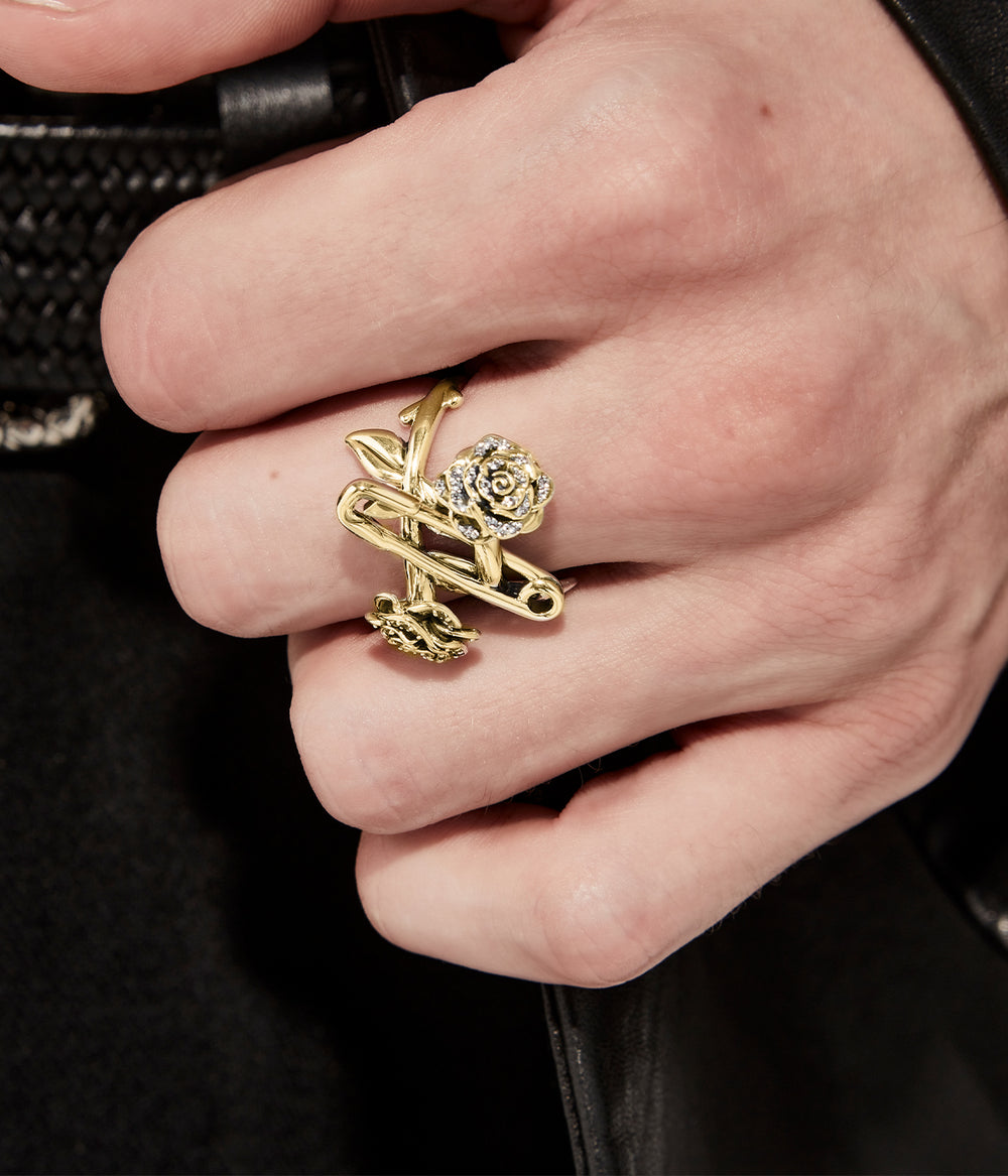 Close up, on model view of gold plated topaz encrusted rose and pin ring for scale and detail.