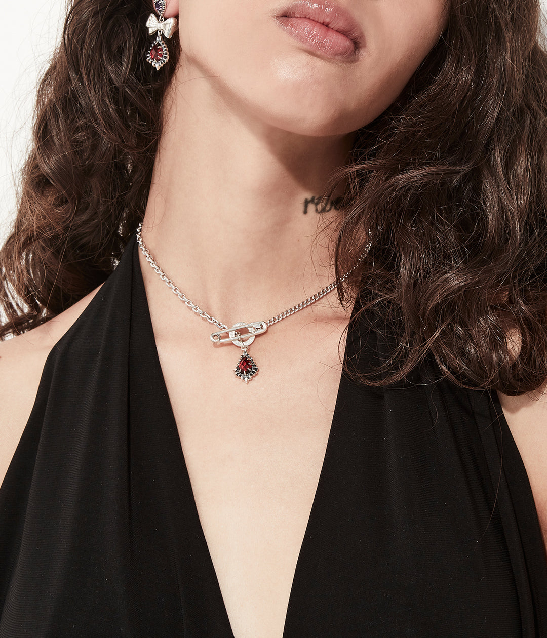 Sterling silver garnet necklace worn on female model for scale