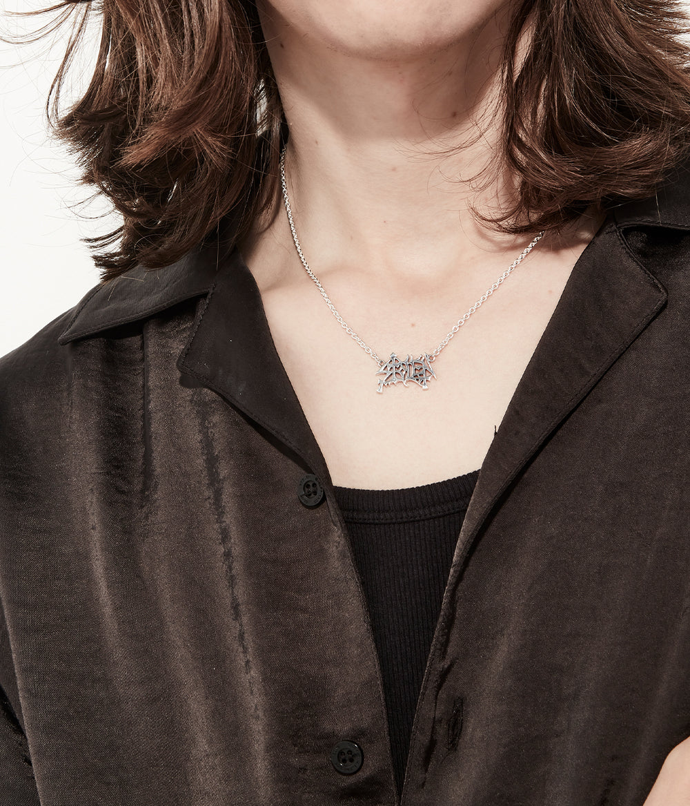 Necklace worn on model to show length and logo scale.
