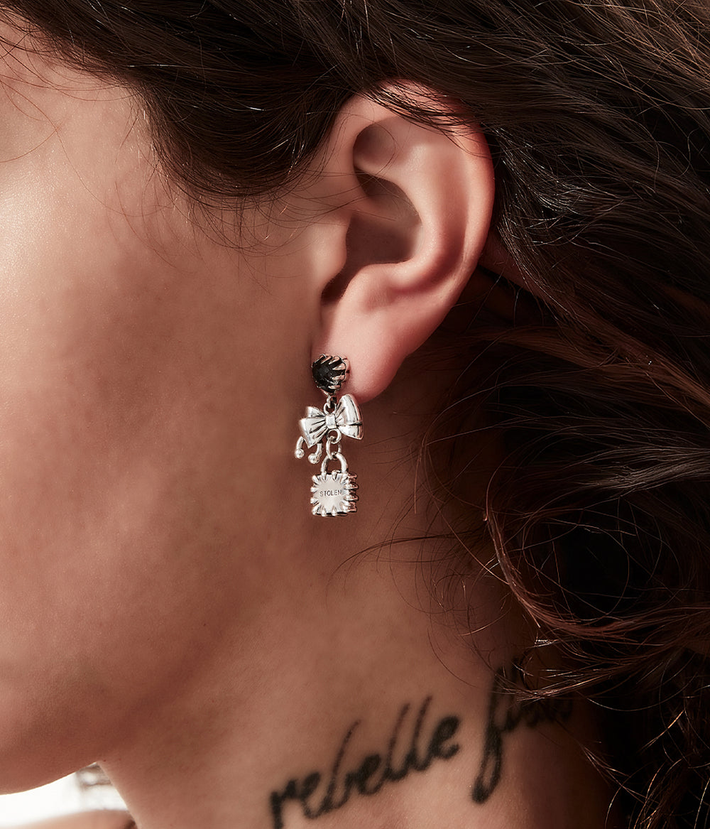 Love Locked Bow Earrings worn on model to show expressive scale and shape.