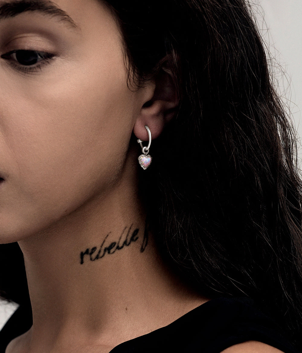 Pink Bello Opal Love Claw Anchor Earring worn on the ear, showing the suspended heart-shaped stone and polished silver hoop.