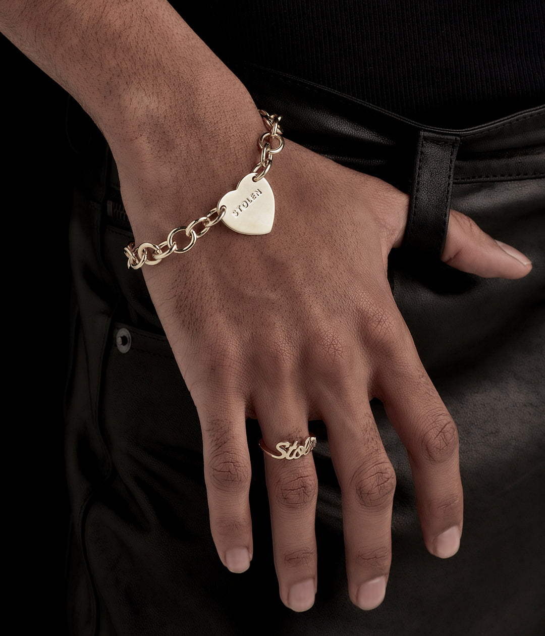 Fine jewellery styling of 9k gold bracelet on model in soft lighting, highlighting timeless shape and premium material.