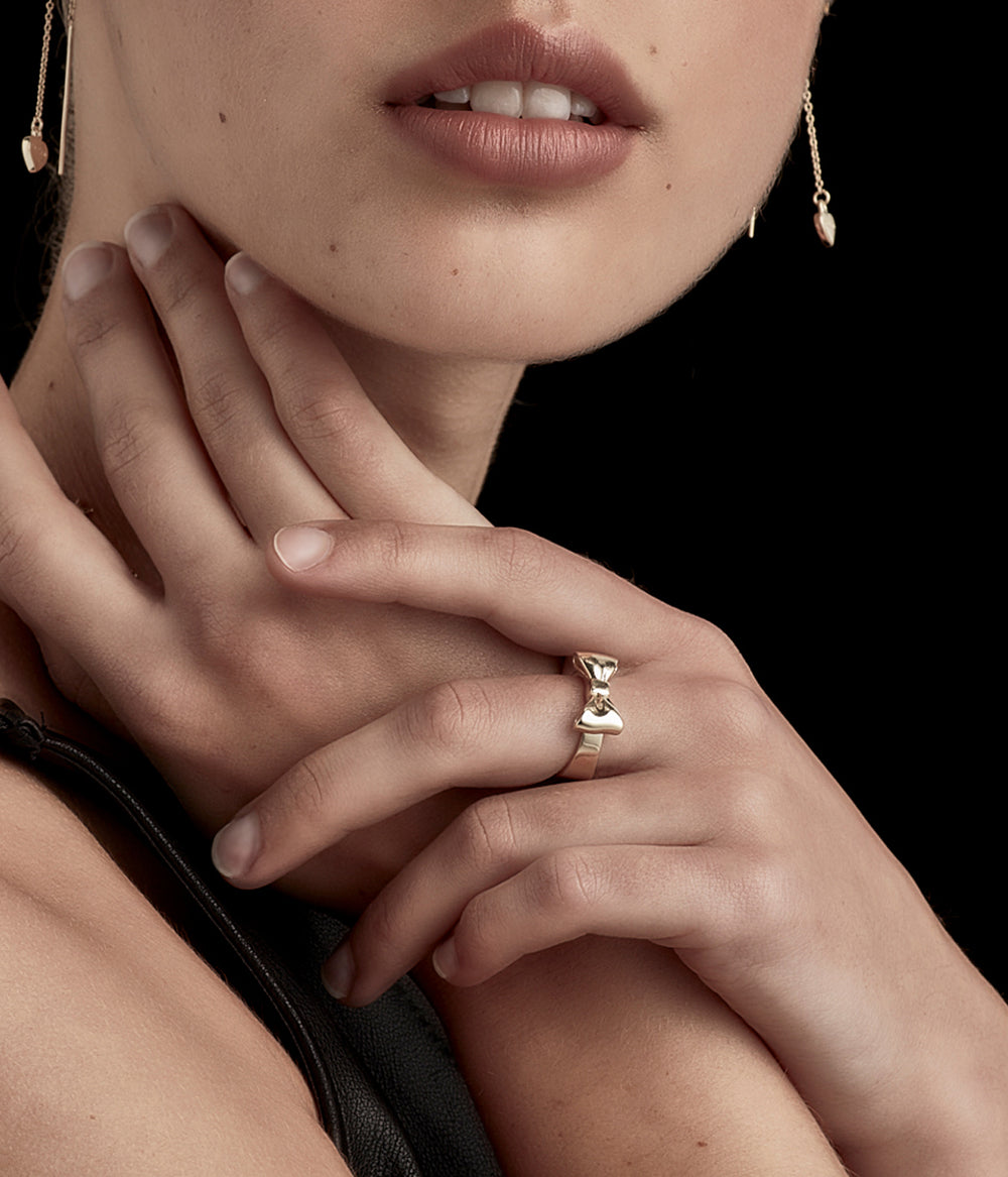 9k solid gold Bow Ring worn by female model in soft lighting, styled simply to show scale and finish.