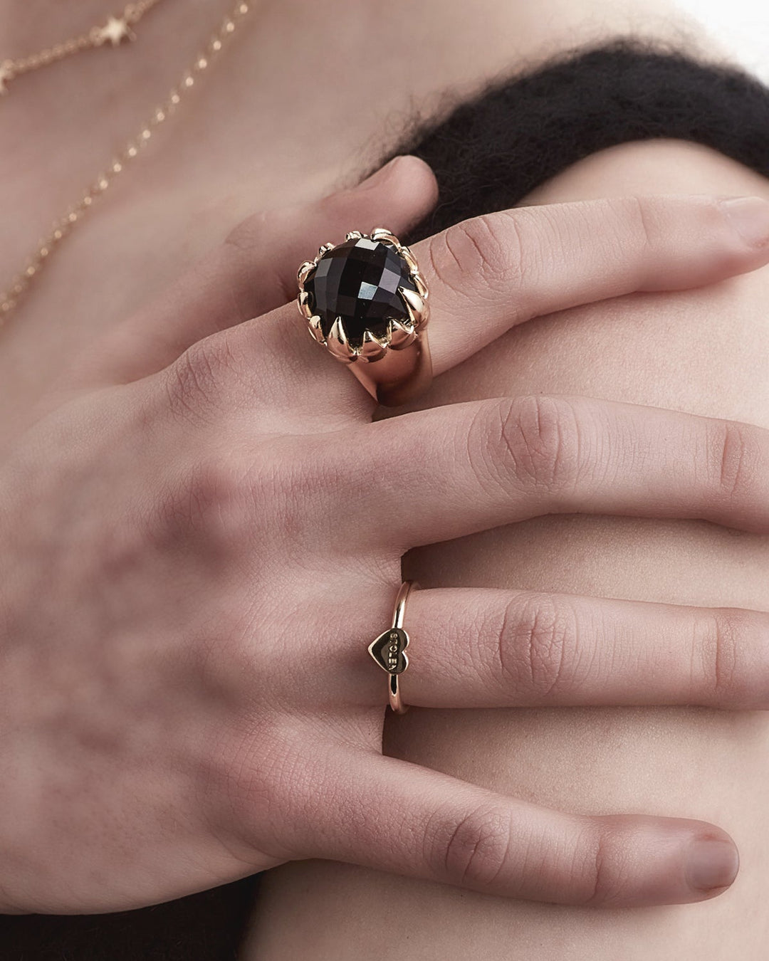 Close-up of female model wearing gold-plated Baby Stolen Heart Ring, styled minimally to highlight the delicate scale and shine.