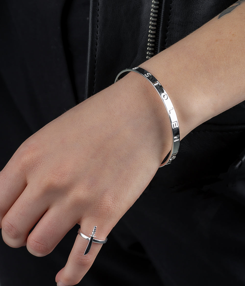 Model shot showing Stolen Bangle styled alone for an elevated, minimal look.