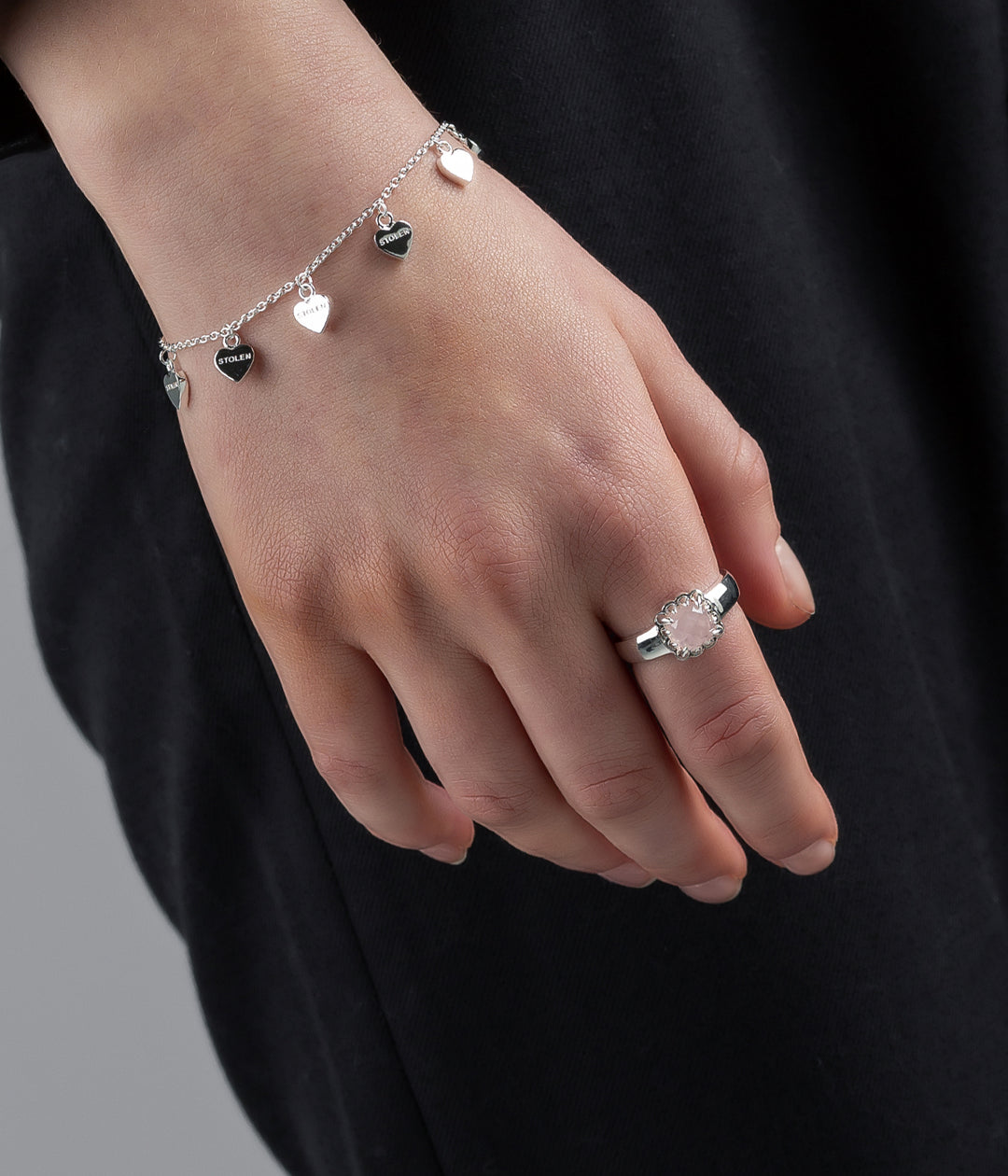 Bracelet worn on model's wrist in natural lighting, showing chain flow and silver tone.