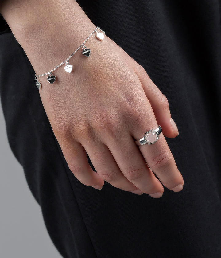 Bracelet worn on model's wrist in natural lighting, showing chain flow and silver tone.
