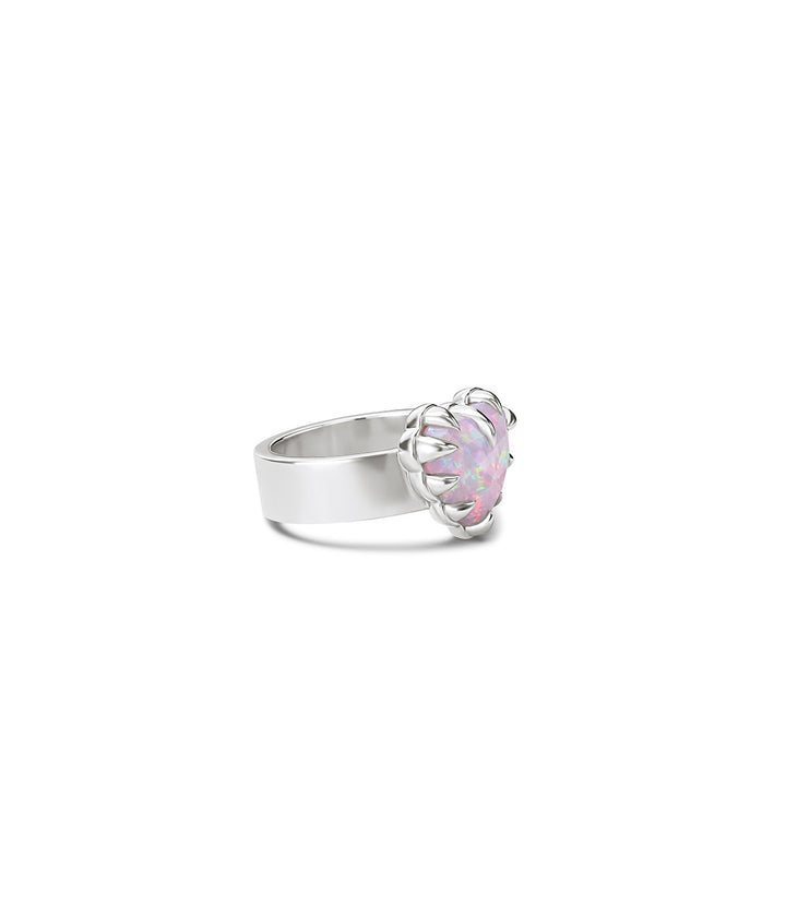 Sterling silver Love Claw Ring by Stolen Girlfriends Club with heart-shaped Pink Bello Opal held in an oversized multi-claw setting on white background. 3/4 view