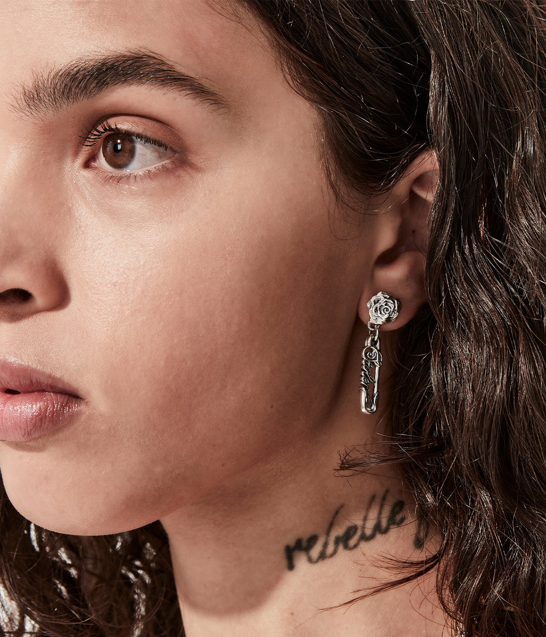 Sterling silver rose pin earrings on female model showing length and scale