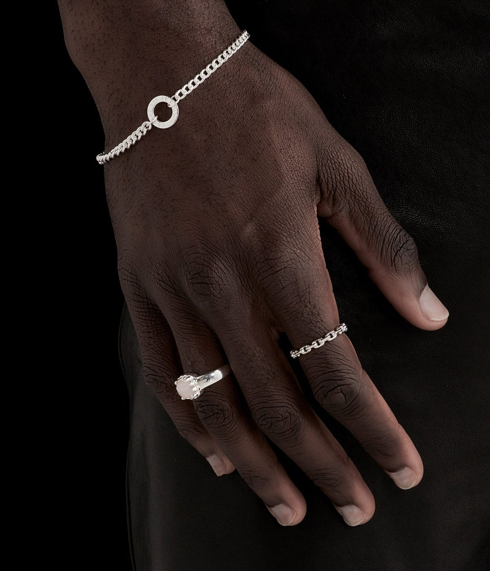 Chain Ring on male model’s hand, styled minimally to show scale and interplay of solid and chain elements.