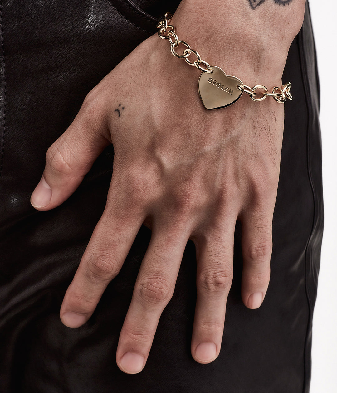 Unisex styling of gold Cold Heart Bracelet on male model, showing fit and finish in natural lighting.