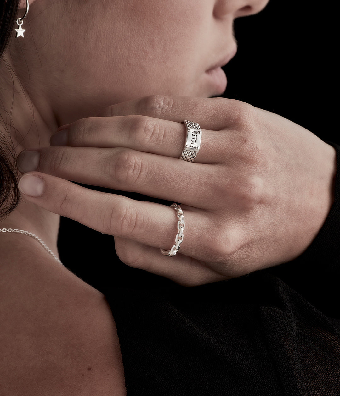 Snake Band Narrow Ring styled on female model’s hand highlighting oxidised texture and slim silhouette in layered silver look