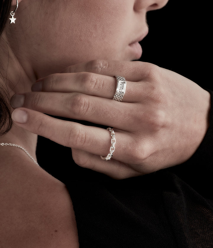 Snake Band Narrow Ring styled on female model’s hand highlighting oxidised texture and slim silhouette in layered silver look